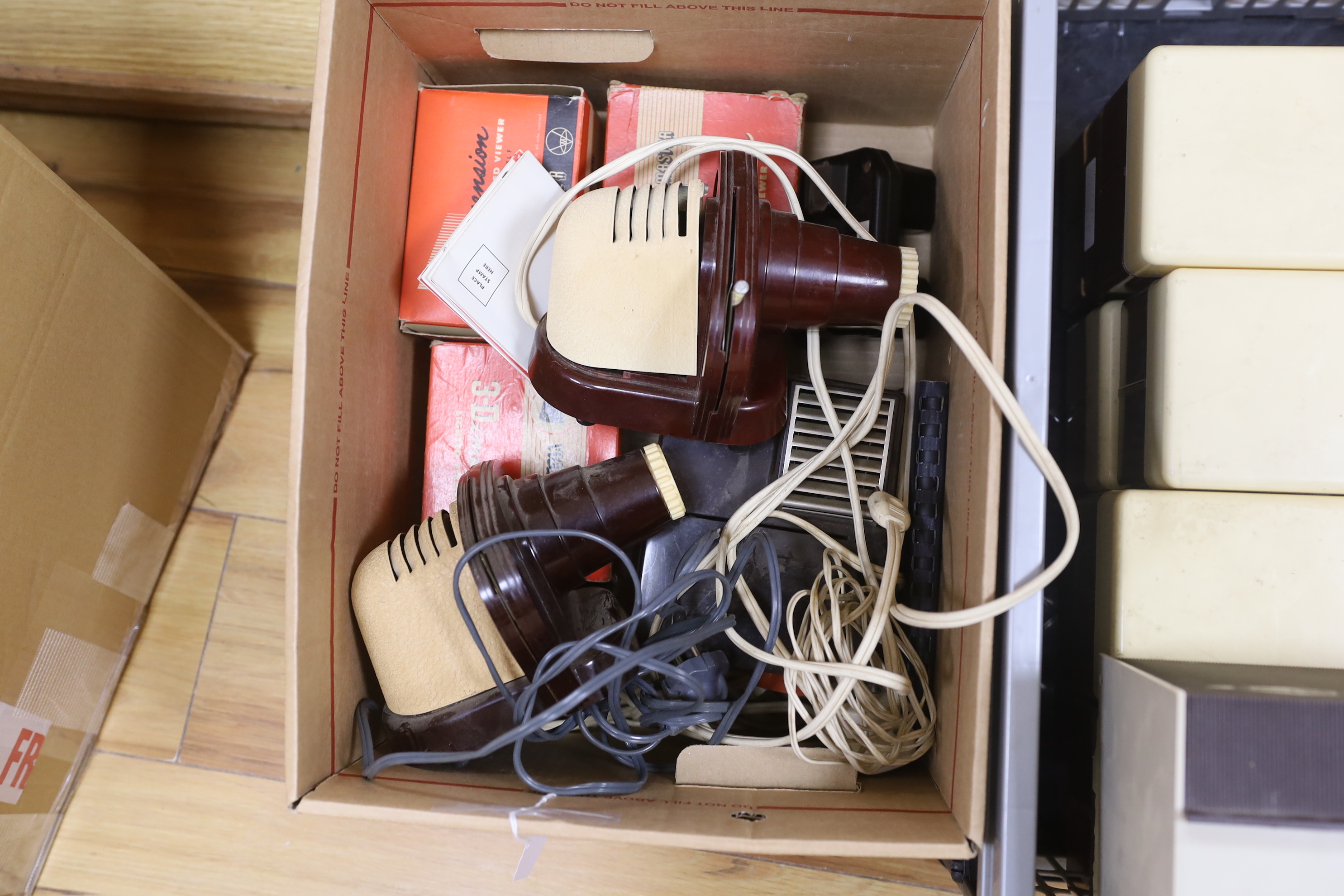 Three View-Master projectors and four View-Master viewers, together with eight View-Master plastic boxes containing a large quantity of reels with subjects including views of the United States, National Parks, Italy, Ger